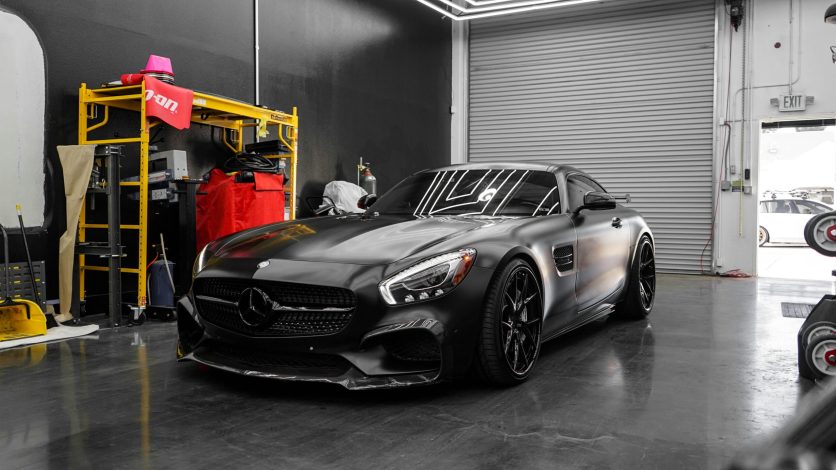 pexels-photo-6969035-6969035 Luxury black sports car with modern design in a clean garage setting, showcasing elegance.